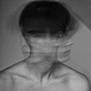 Motion blur photo of man shaking head